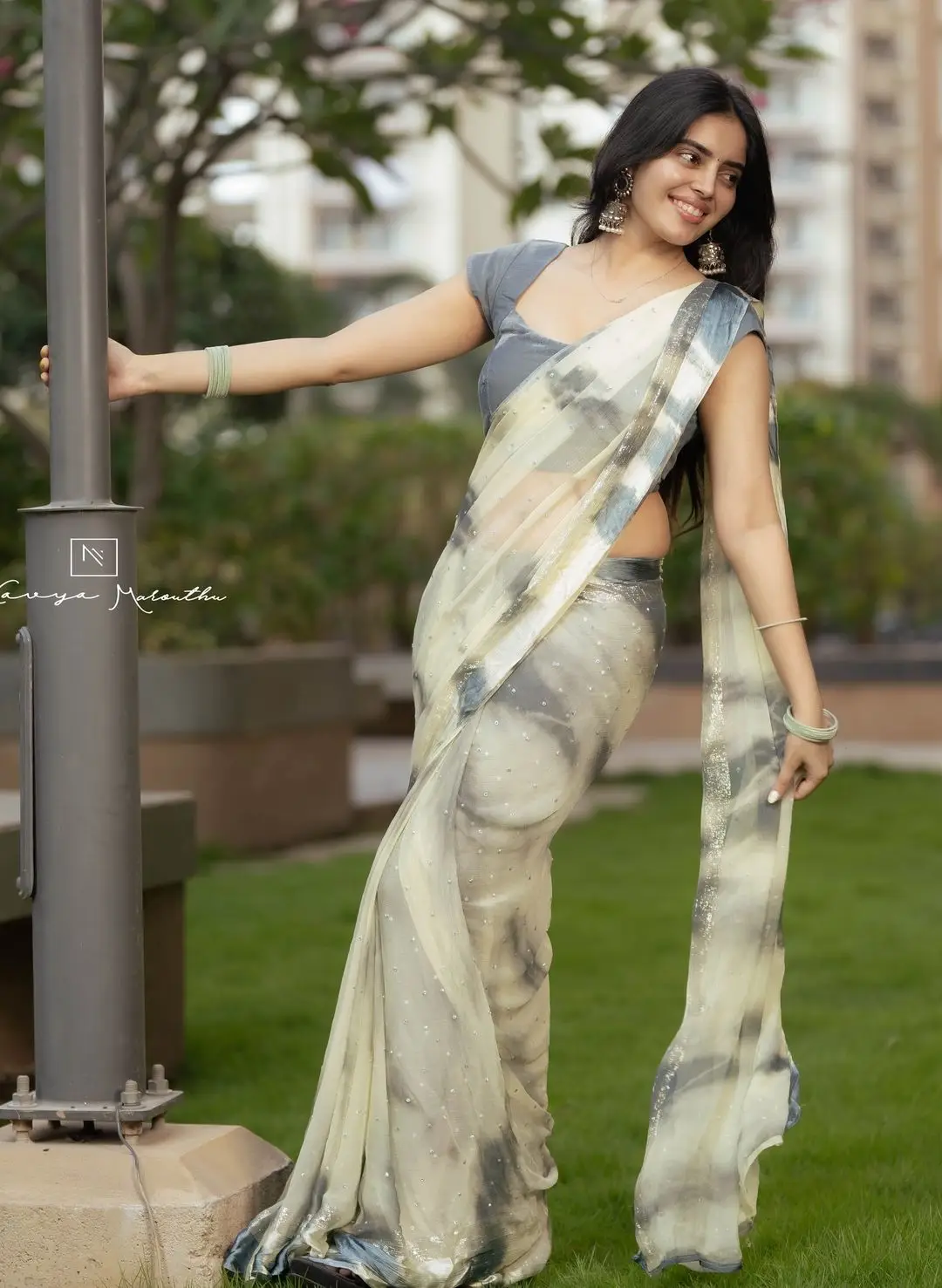 Navya Marouthu Wearing White Saree Sleeveless Black Blouse